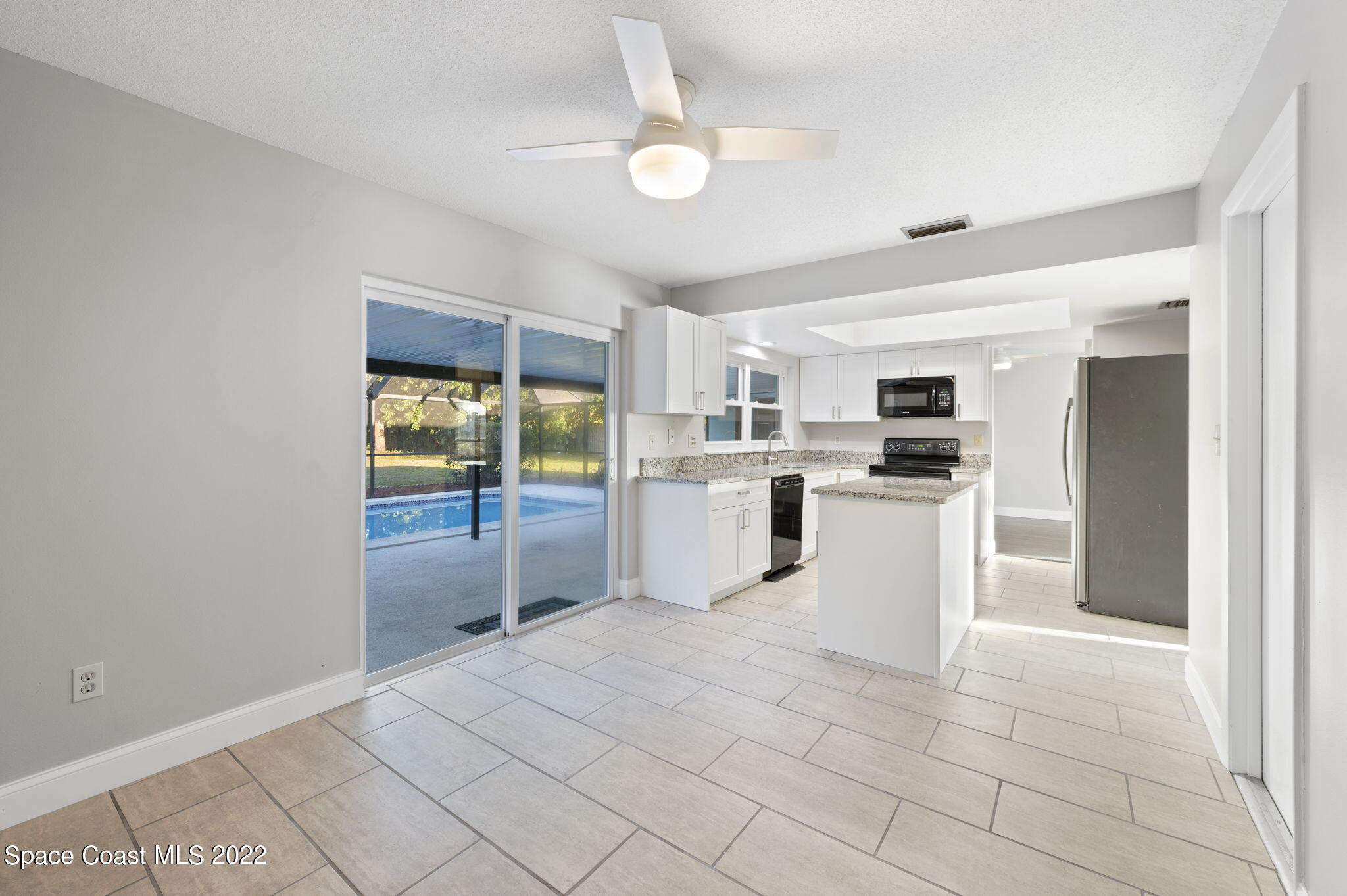 1141 Cromey Road Northeast Palm Bay, FL 32905 - Photo 11 of 27 a kitchen with white cabinets and white appliances