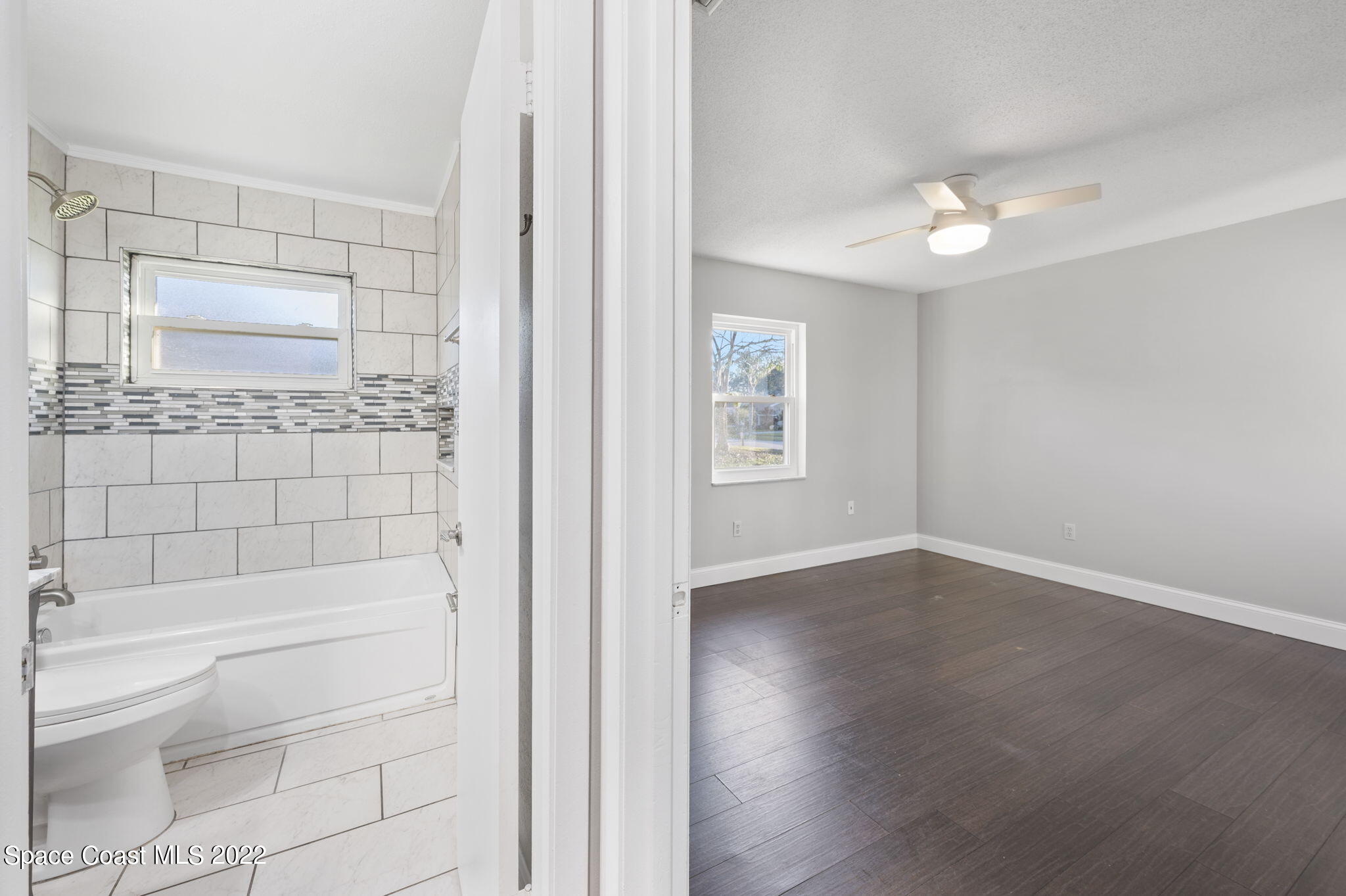1141 Cromey Road Northeast Palm Bay, FL 32905 - Photo 16 of 27 a bathroom with a toilet tub and shower
