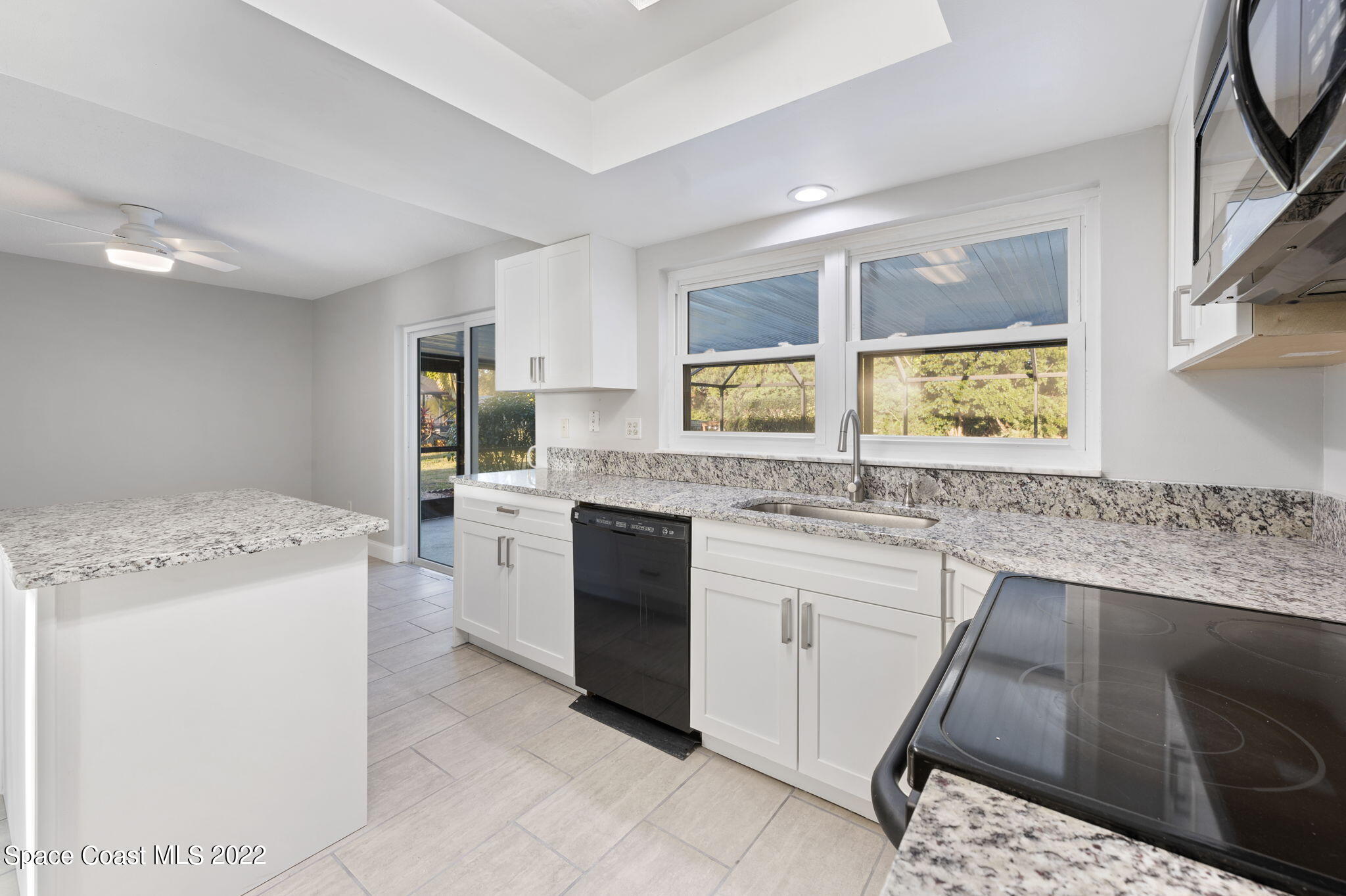 1141 Cromey Road Northeast Palm Bay, FL 32905 - Photo 3 of 27 a kitchen with a sink stove and cabinets