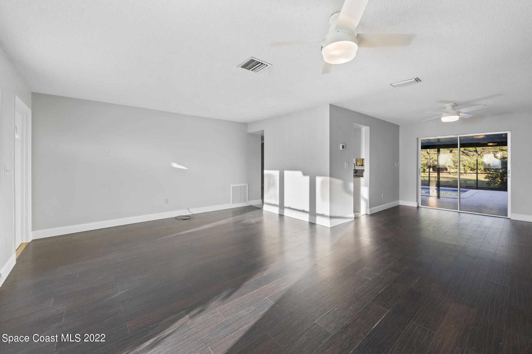 1141 Cromey Road Northeast Palm Bay, FL 32905 - Photo 4 of 27 a view of an empty room with window and wooden floor