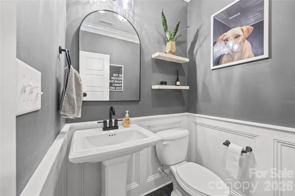 a bathroom with a sink a toilet and mirror