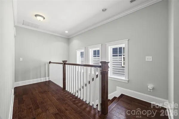 a view of a hallway with window and stairs