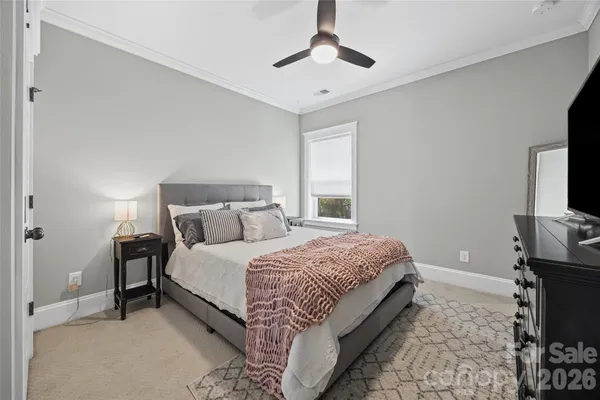 a bedroom with bed and tv