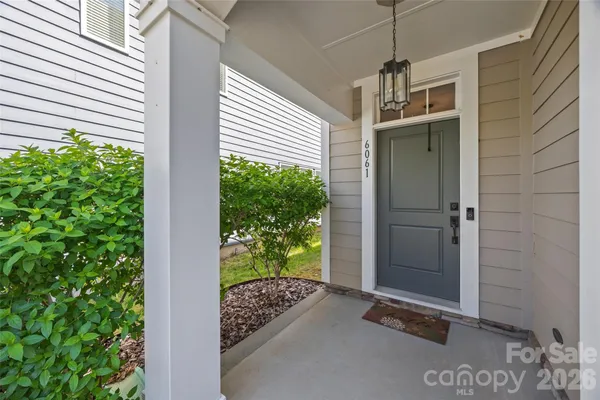 a view of a porch with a door and wooden floor
