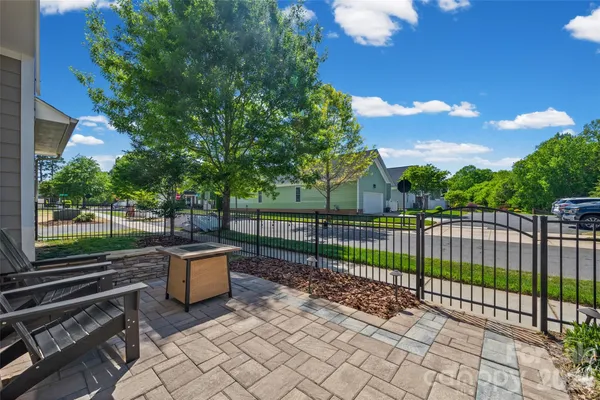 a view of a fence and trees in a yard