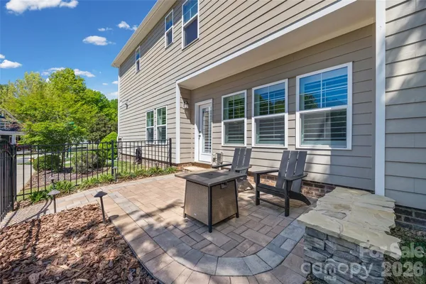 a view of a house with backyard sitting area and garden