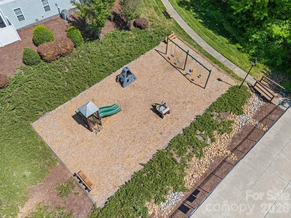 a view of a backyard with plants and outdoor seating