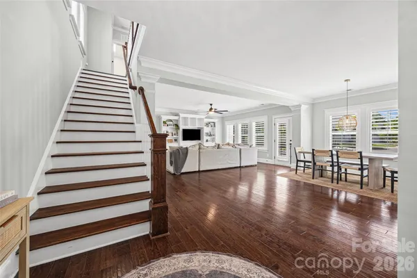 a view of entryway and hall with wooden floor