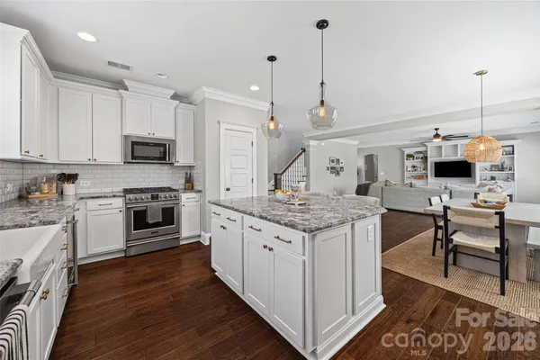 a kitchen with a stove a sink and a refrigerator