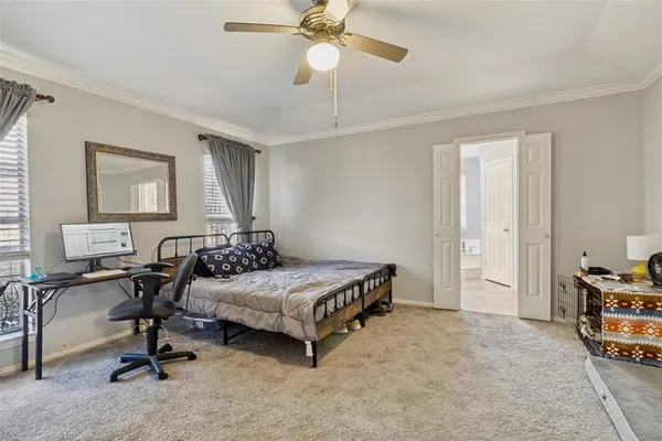 a bedroom with bed and a chandelier