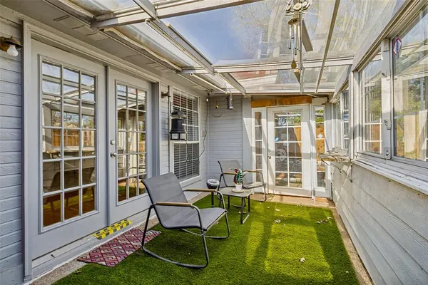 a swimming pool with outdoor seating and yard