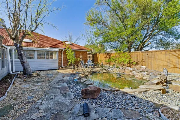 a view of a house with swimming pool and sitting area