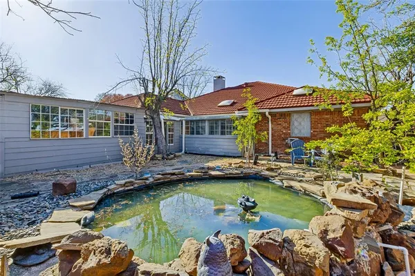 a view of a house with swimming pool and sitting area