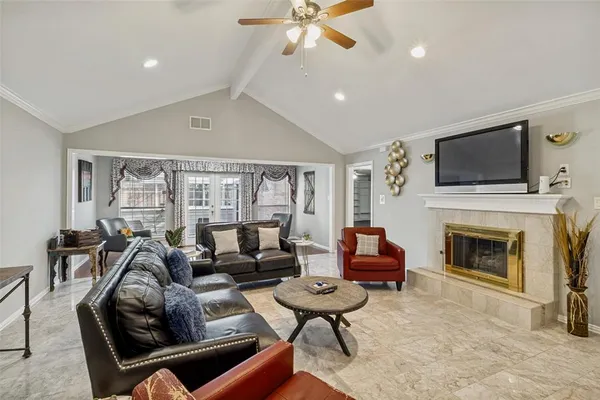 a living room with furniture a fireplace and a flat screen tv