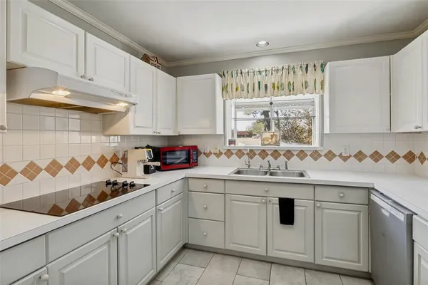 a kitchen with white cabinets sink and white appliances