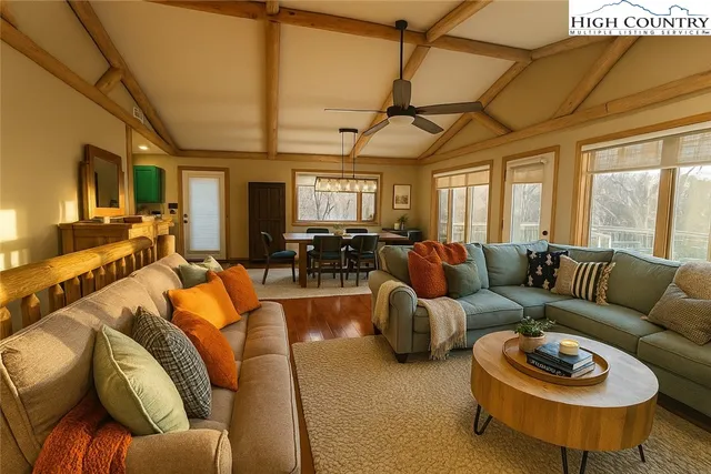 a living room with furniture a couch and a chandelier