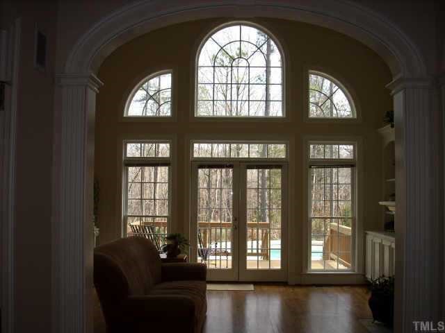 8692 Barrett Ridge Road Wake Forest, NC 27587 - Photo 3 of 12 The dramatic family room windows provide fantastic views of the inground pool and beautifully landscaped backyard.