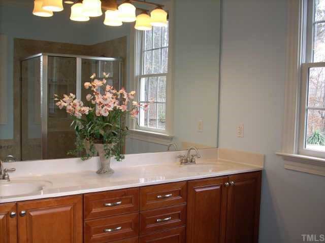 8692 Barrett Ridge Road Wake Forest, NC 27587 - Photo 8 of 12 Luxurious master bath with dual vanity sinks, tiled floor, separate shower and garden tub with jets.