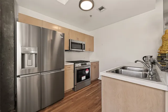 a kitchen with stainless steel appliances granite countertop a stove and a microwave