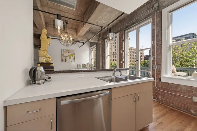 a view of a kitchen with a sink and wooden floor