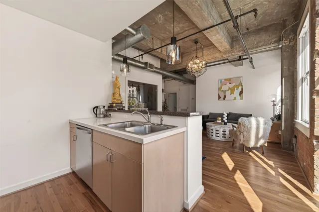 a kitchen with granite countertop a sink and a stove top oven
