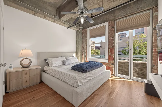 a spacious bedroom with a bed and a chandelier