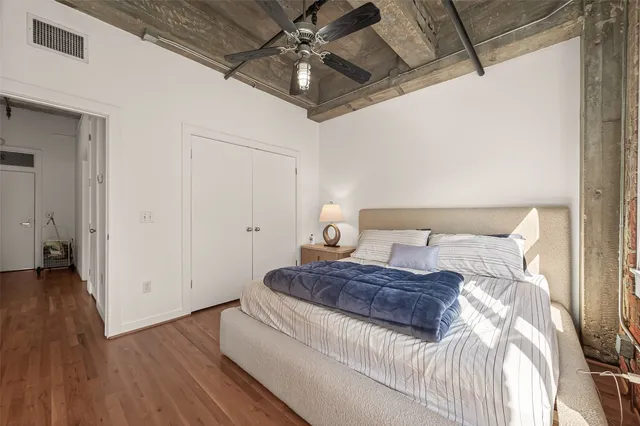 a living room with couch and large window with wooden floor