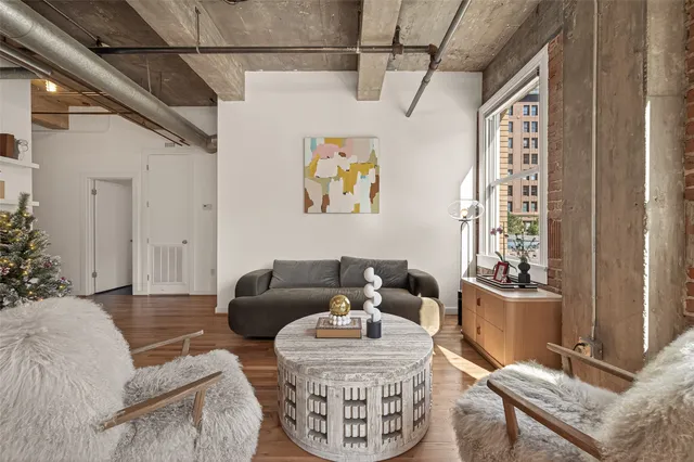 a living room with furniture and a floor to ceiling window