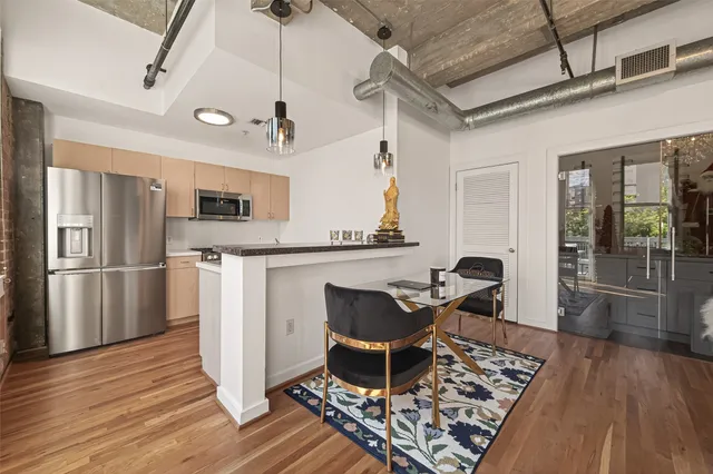a living room with furniture a chandelier and wooden floor