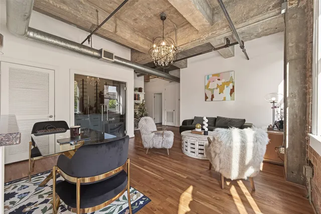 a view of a hallway with dining room and wooden floor