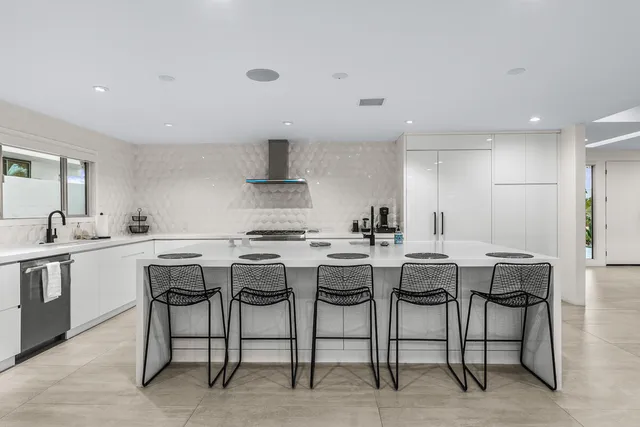 a view of a dining room with furniture and a floor to ceiling window