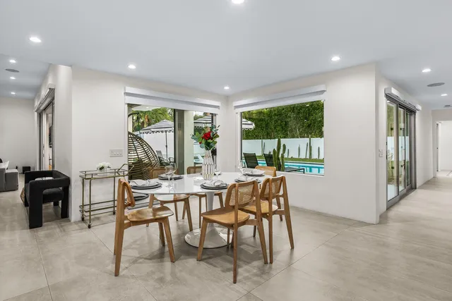 a bathroom with a double vanity sink mirror and next to a window
