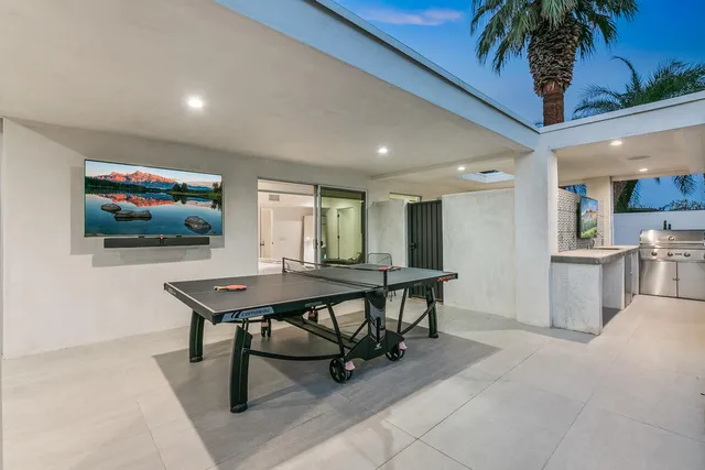 a view of a house with swimming pool and sitting area