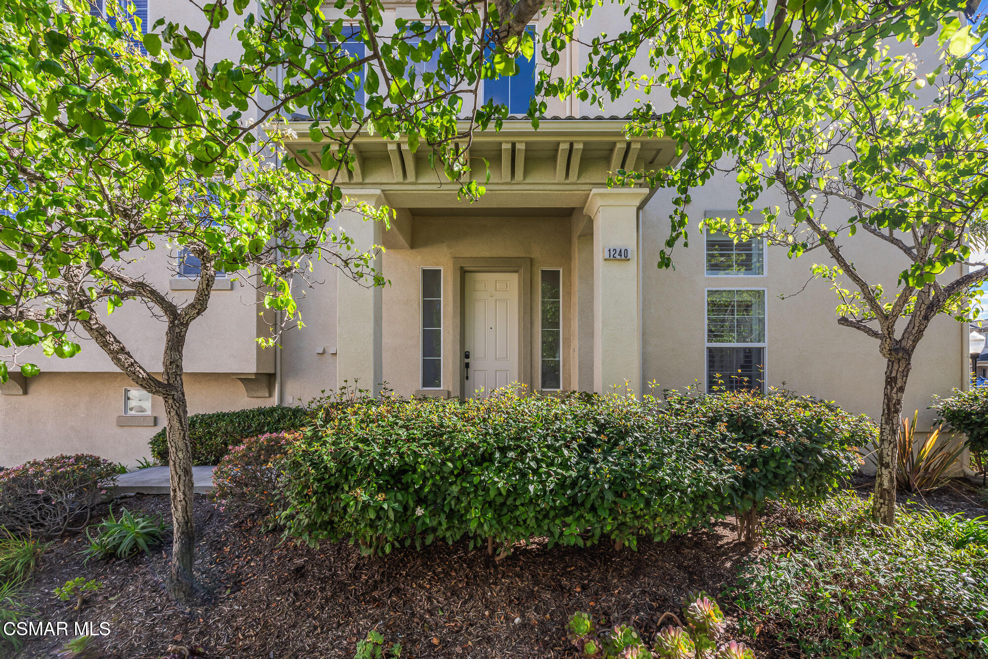 1240 Bayside Lane Oxnard, CA 93035 - Photo 3 of 51 a view of a wooden door and a tree