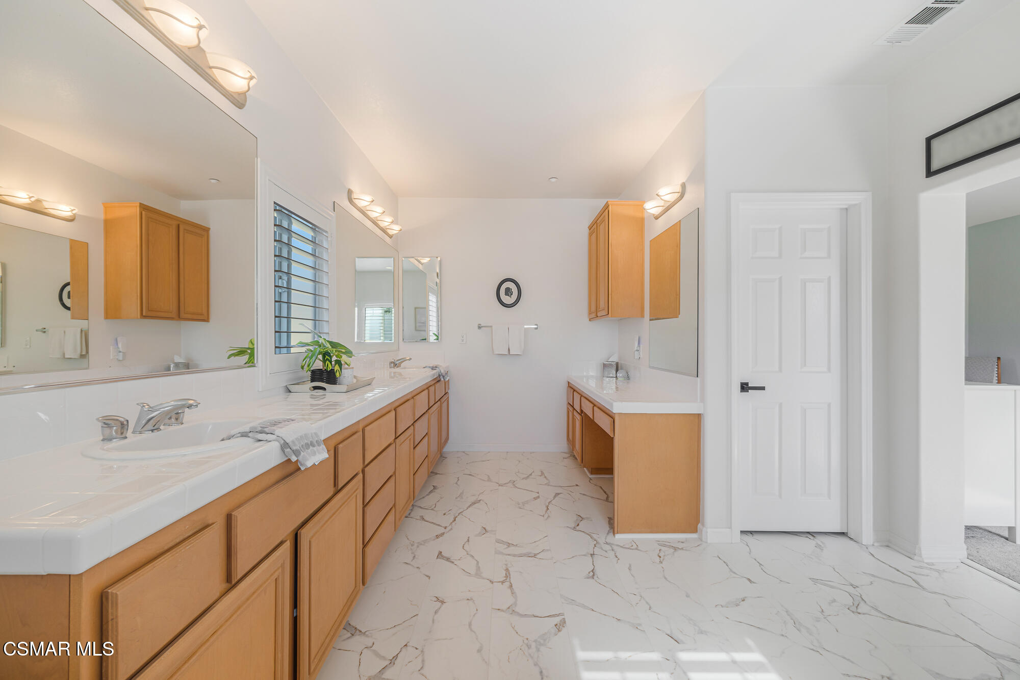 1240 Bayside Lane Oxnard, CA 93035 - Photo 33 of 51 a large bathroom with a double vanity sink a mirror and a bathtub