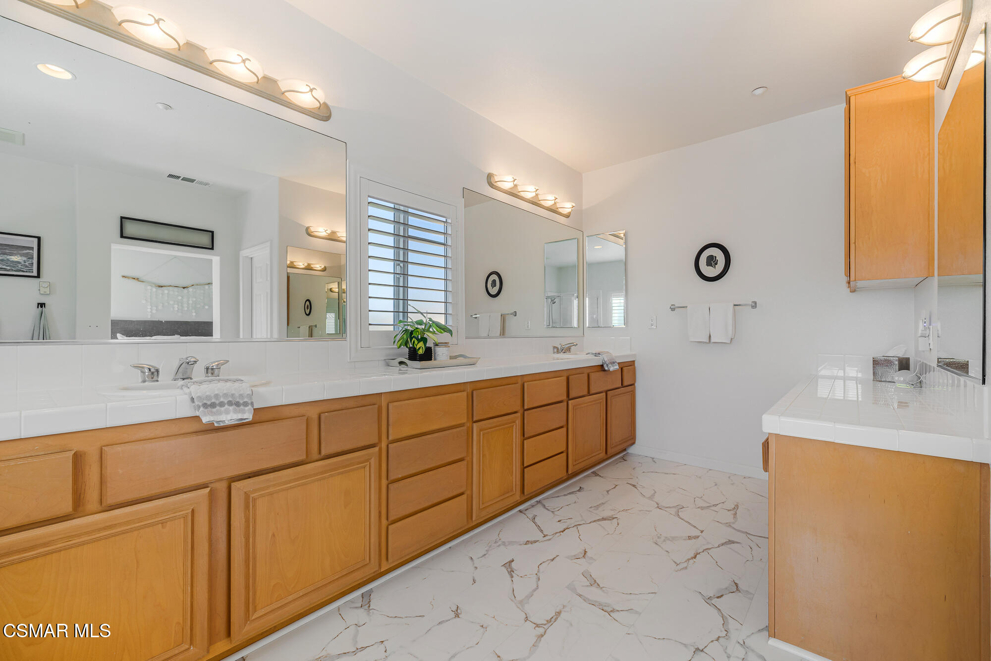 1240 Bayside Lane Oxnard, CA 93035 - Photo 34 of 51 a spacious bathroom with a double vanity sink mirror and