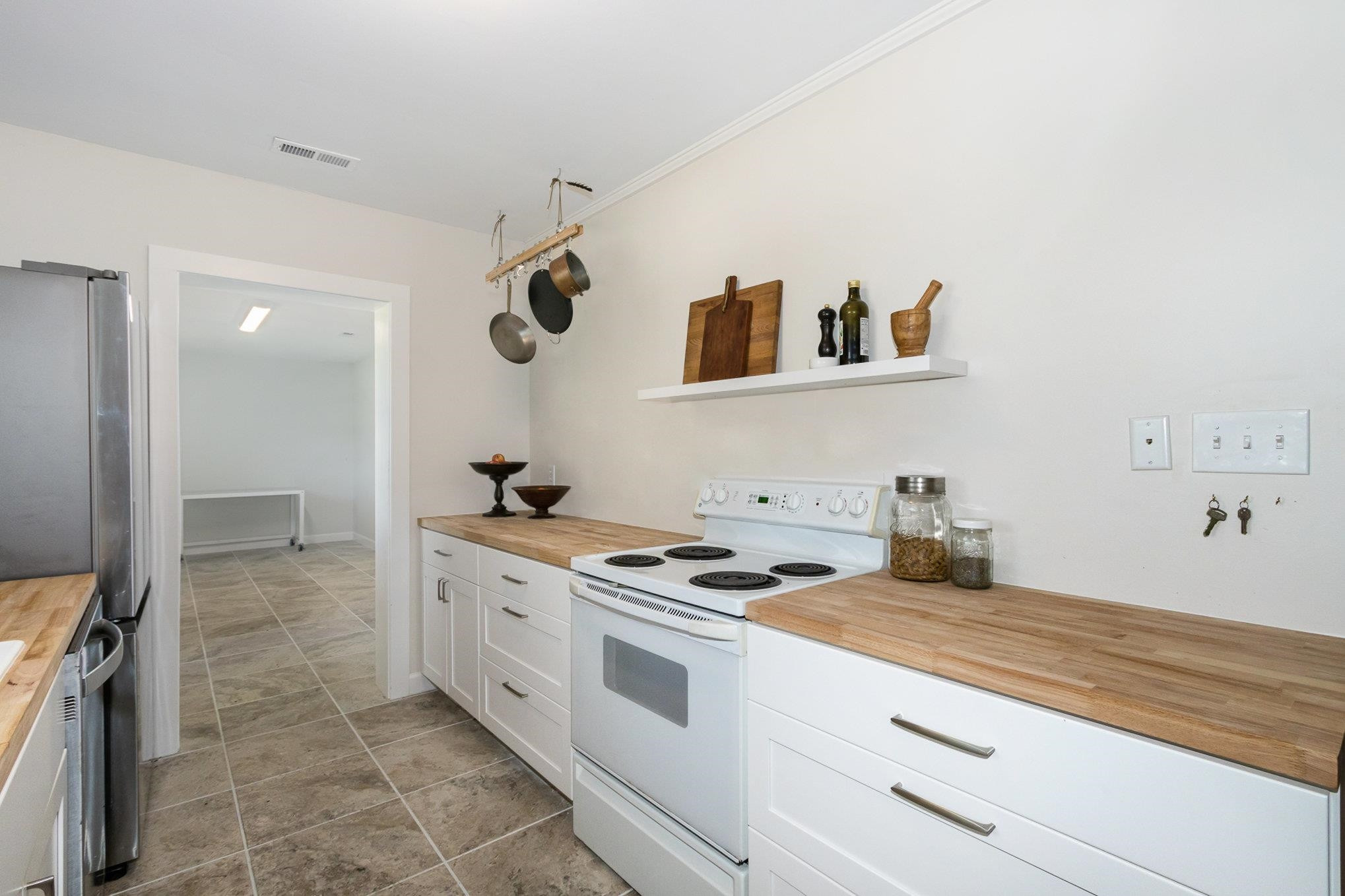 10611 Rougemont Road Bahama, NC 27503 - Photo 12 of 66 a kitchen with granite countertop a stove and a sink