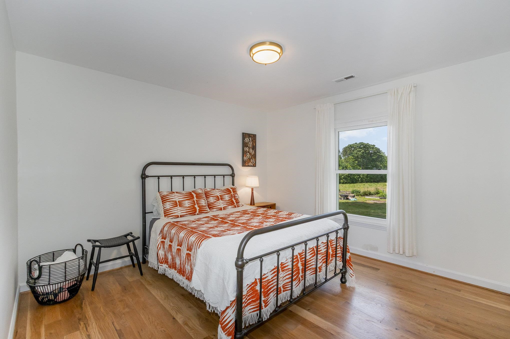10611 Rougemont Road Bahama, NC 27503 - Photo 17 of 66 a bedroom with a bed and a window