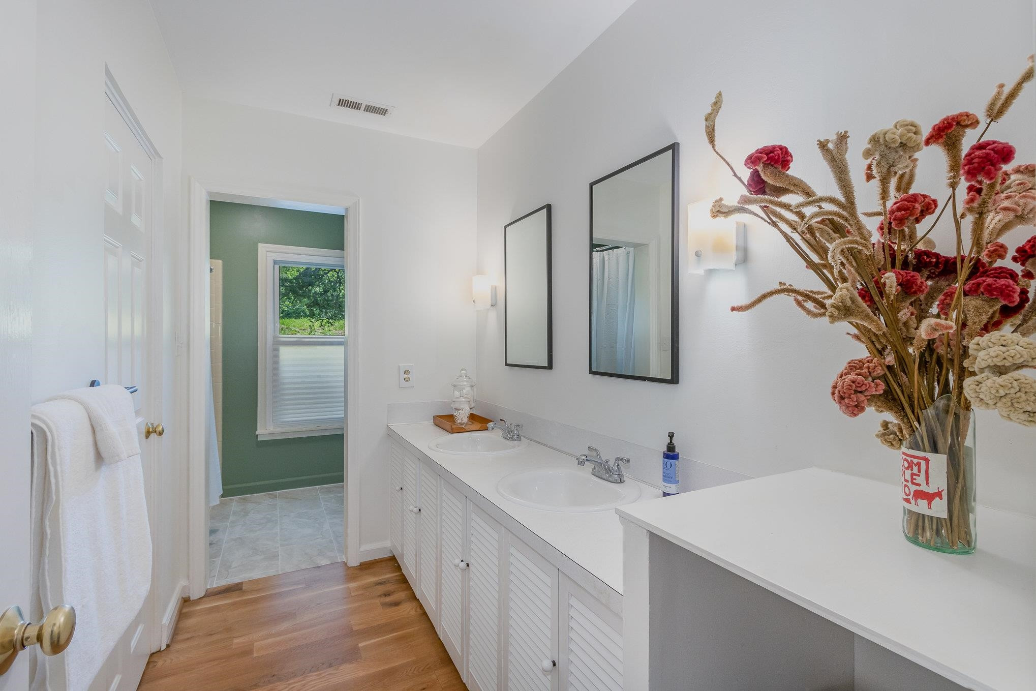 10611 Rougemont Road Bahama, NC 27503 - Photo 19 of 66 a bathroom with a sink a mirror and a shower