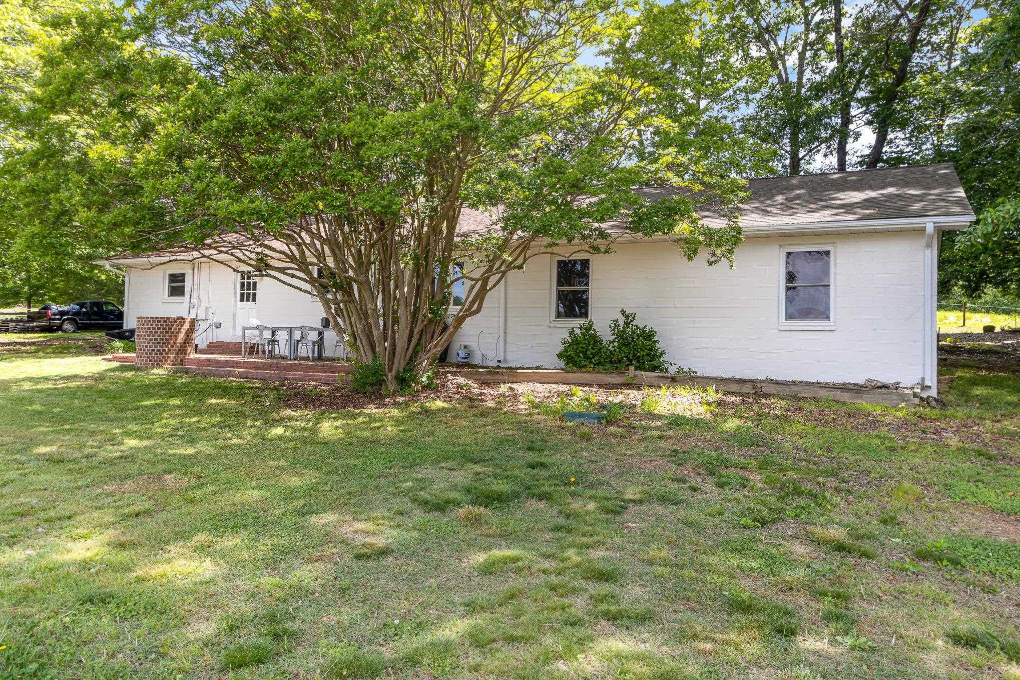 10611 Rougemont Road Bahama, NC 27503 - Photo 22 of 66 a front view of a house with garden