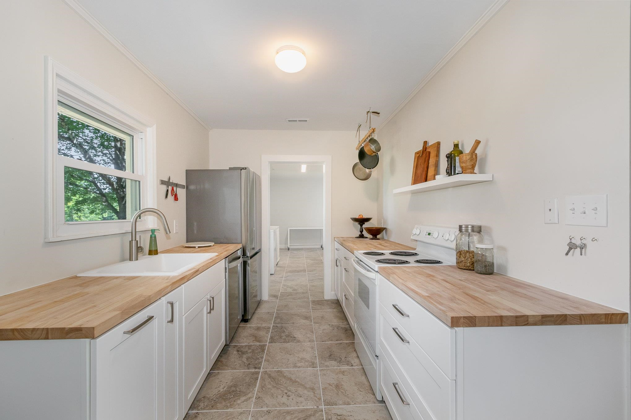 10611 Rougemont Road Bahama, NC 27503 - Photo 10 of 66 a large kitchen with a stove sink and refrigerator