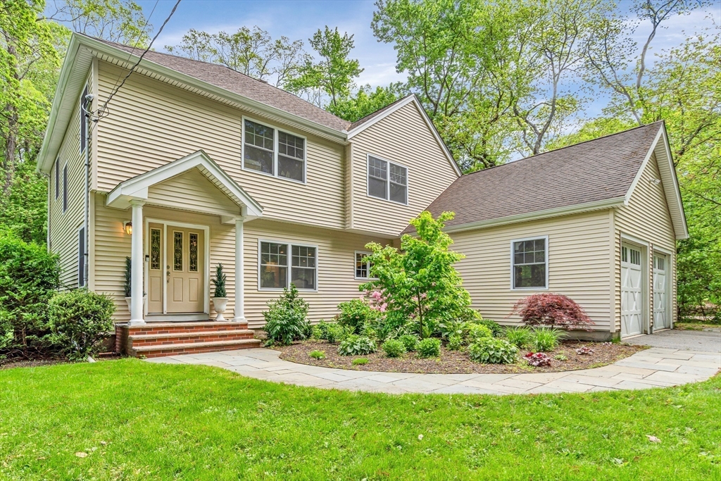 a front view of a house with garden