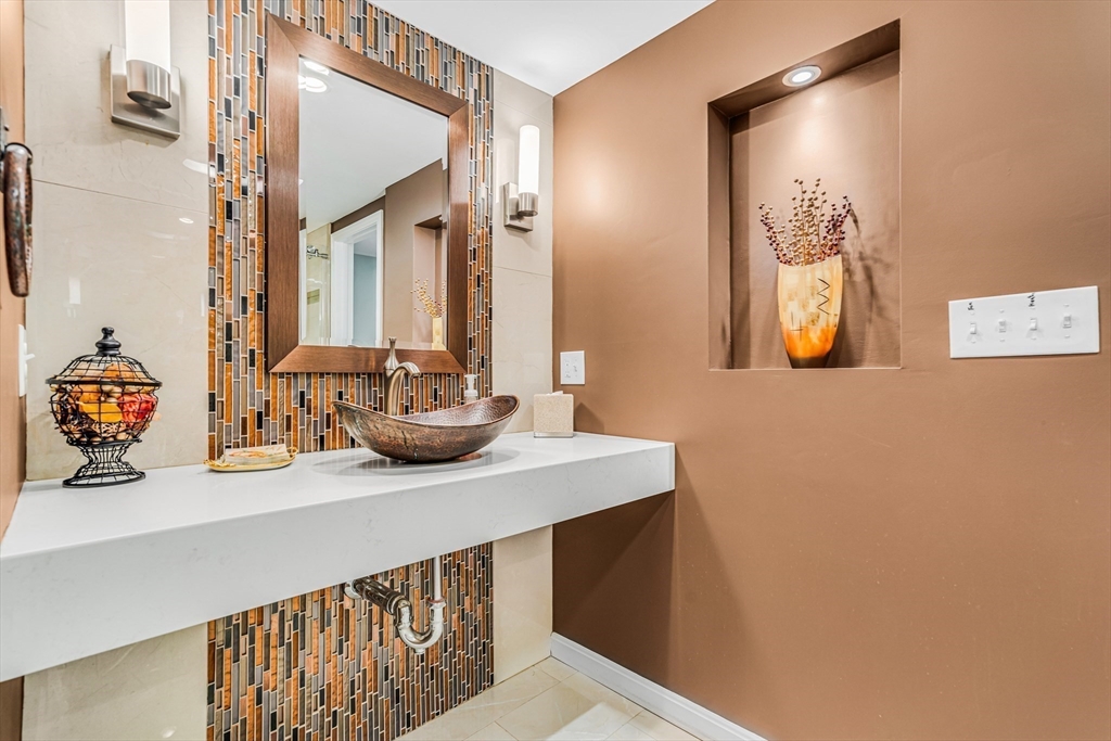 121 Shade Street Lexington, MA 02421 - Photo 16 of 42 a bathroom with a sink and a mirror