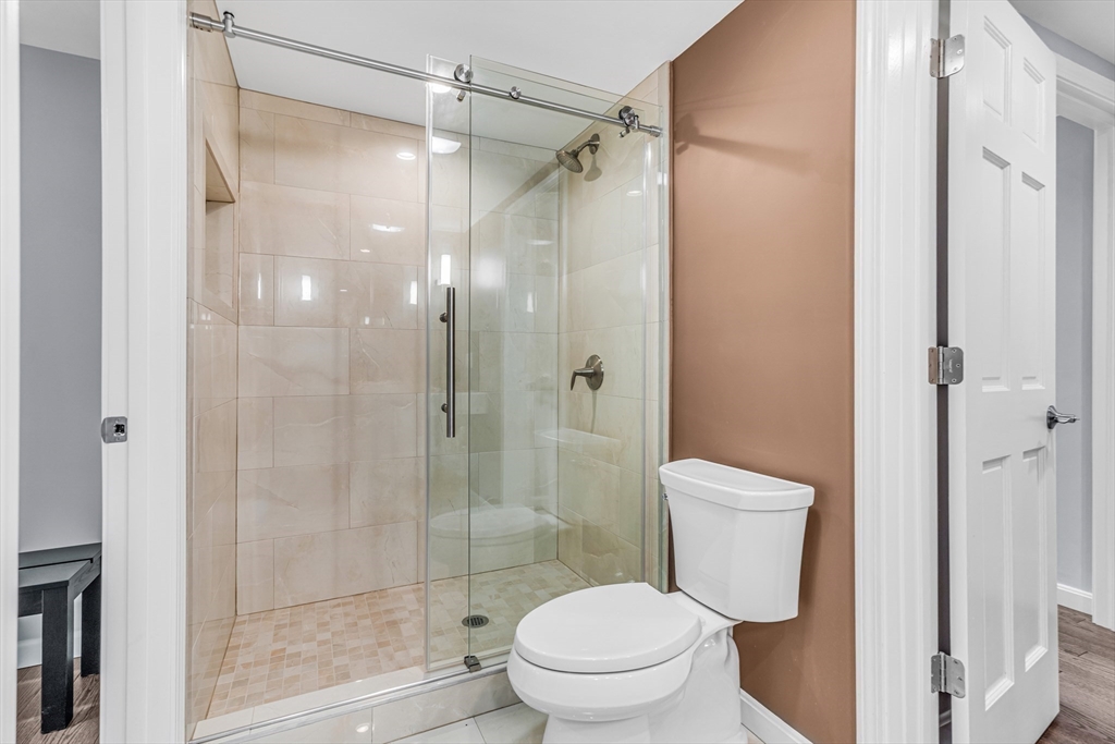 121 Shade Street Lexington, MA 02421 - Photo 17 of 42 a bathroom with a shower a toilet and a sink