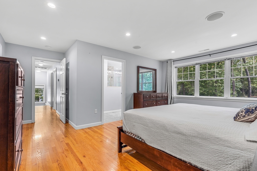 121 Shade Street Lexington, MA 02421 - Photo 21 of 42 a spacious bedroom with a large bed and a large window