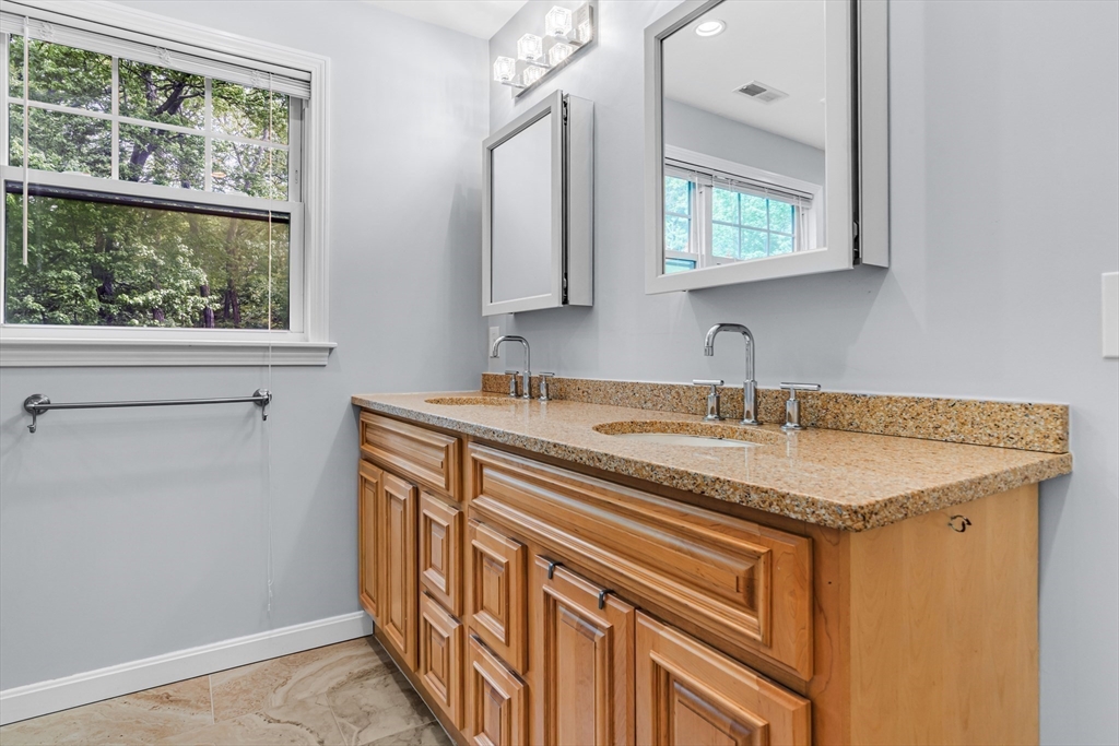 121 Shade Street Lexington, MA 02421 - Photo 25 of 42 a bathroom with a granite countertop sink and a mirror