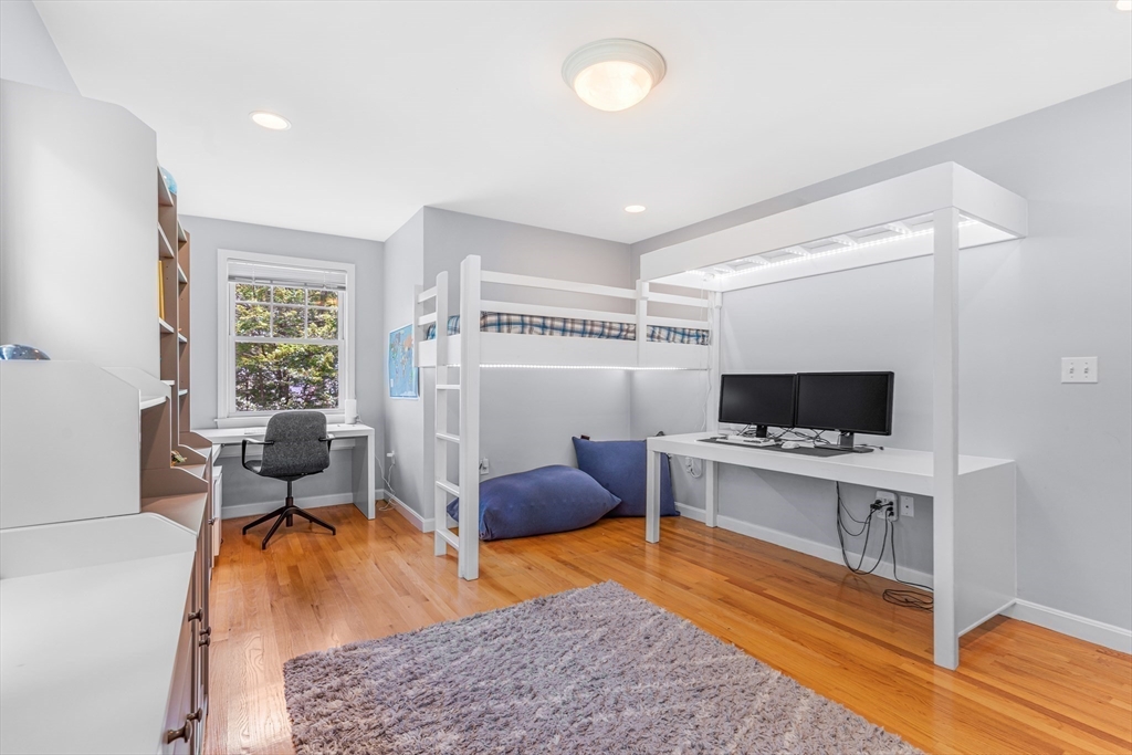 121 Shade Street Lexington, MA 02421 - Photo 28 of 42 a living room with furniture and a flat screen tv