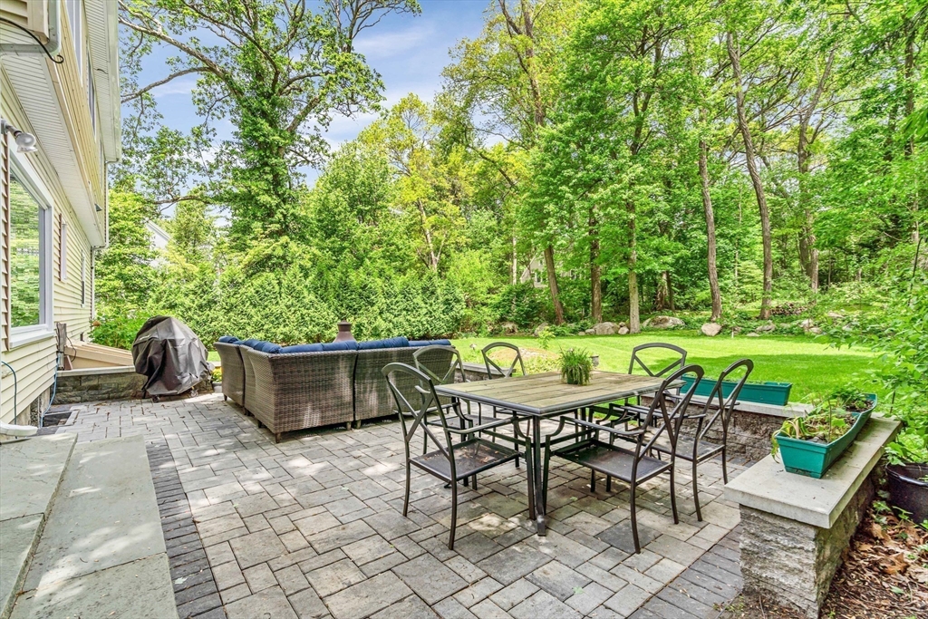 121 Shade Street Lexington, MA 02421 - Photo 38 of 42 a table and chairs sitting in a backyard