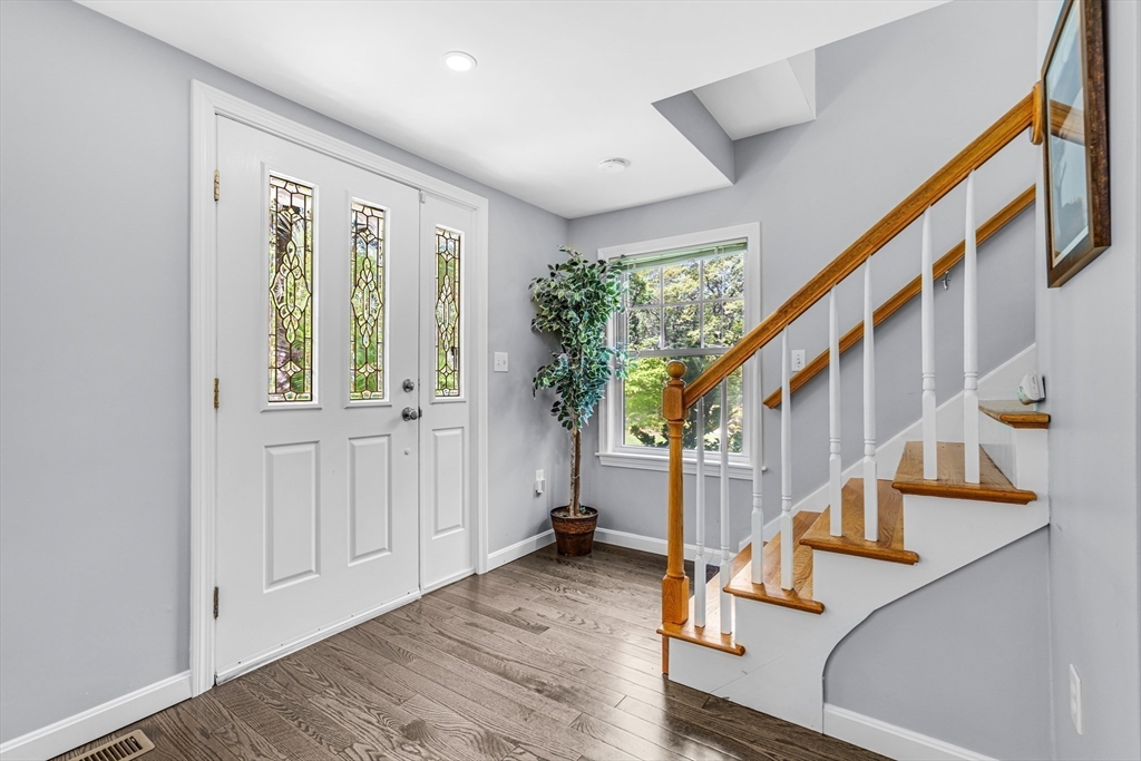 121 Shade Street Lexington, MA 02421 - Photo 5 of 42 a view of an entryway with wooden floor and stairs
