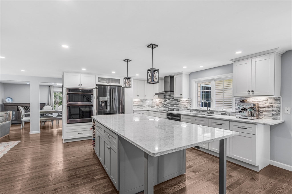 121 Shade Street Lexington, MA 02421 - Photo 8 of 42 a large kitchen with kitchen island a sink table and chairs